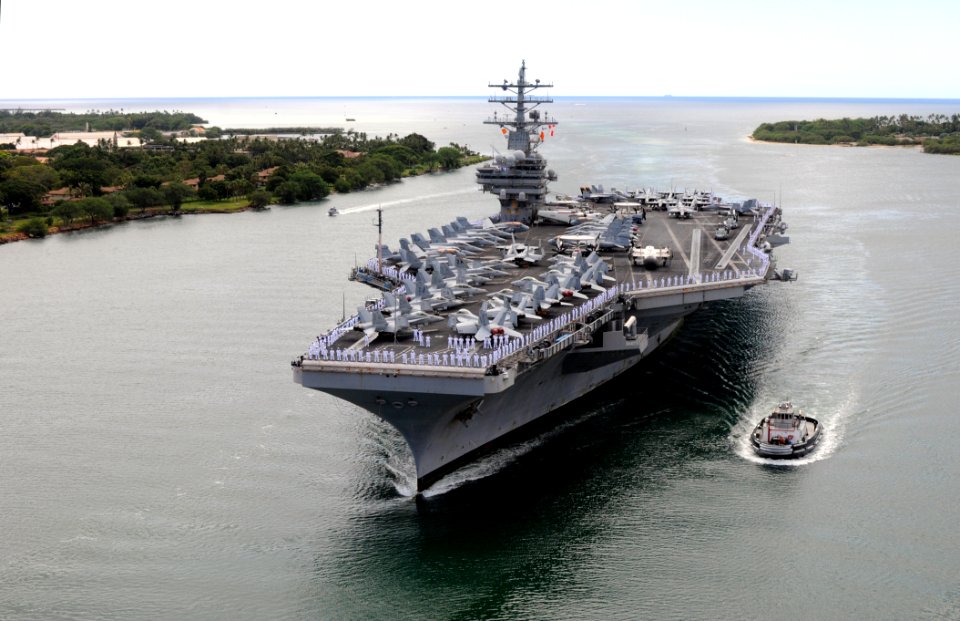 US Navy 091013-N-1635S-005 Sailors aboard the aircraft carrier USS Ronald Reagan (CVN 76) man the rails as the ship pulls into Pearl Harbor, Hawaii. Ronald Reagan made a scheduled port visit in Honolulu
