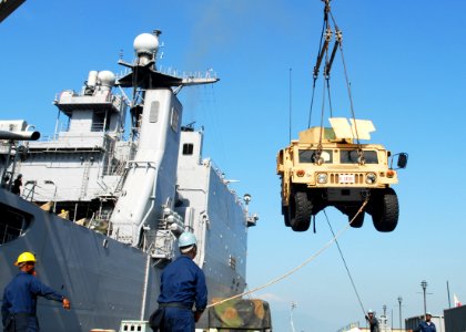 US Navy 091013-N-6692A-087 Sailors assigned to the amphibious dock landing ship USS Tortuga (LSD 46) offload Marine Corps vehicles photo