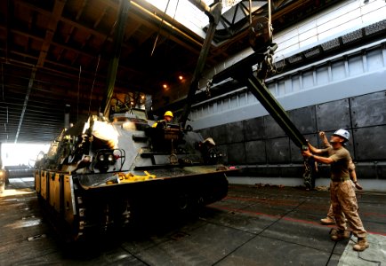 US Navy 091015-N-5345W-100 gt. Alexander Tamez, assigned to Combat Logistics Battalion (CLB) 22 of the 22nd Marine Expeditionary Unit (22 MEU), steadies the lift bar of an M88A2 Hercules recovery vehicle