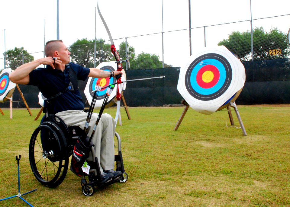 US Navy 091014-N-6326B-122 U.S. Military Summit archery instructor Russell Wolfe, member of the U.S. Paralympic Archery National Team, fires a test shot from his bow