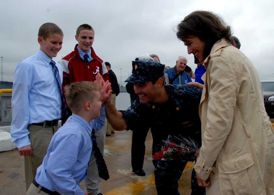 US Navy 091015-N-7705S-116 Lt. Cmdr. Seth Burton, executive officer of the Los Angeles-class attack submarine USS Newport News (SSN 750), receives a high five from his son