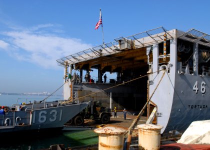 US Navy 091013-N-6692A-064 Sailors and Marines offload Marine Corps vehicles from the amphibious dock landing ship USS Tortuga (LSD 46) onto a landing craft utility photo