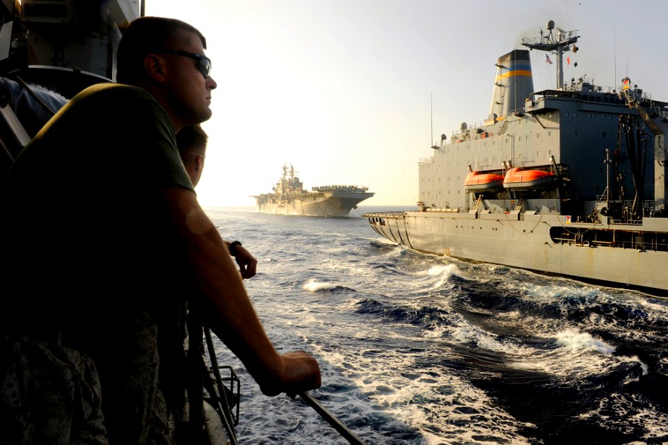 US Navy 091016-N-5345W-062 Marines watch as the amphibious assault ship USS Bataan (LHD 5) prepares to pull alongside the Military Sealift Command fleet replenishment oiler USNS Kanawha (T-AO 196) to conduct a replenishment-at