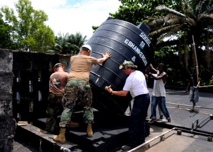 US Navy 091015-N-1429M-129 Dutch marines and sailors aboard the Dutch navy amphibious ship HNLMS Johan De Witt (L 801) and U.S. Navy Seabees assigned to Naval Mobile Construction Battalion (NMCB) 3, remount a water tower