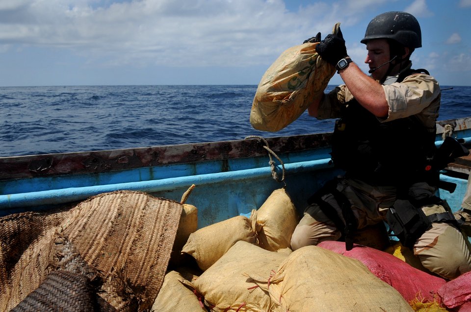US Navy 091015-N-4154B-272 Gas Turbine Technician (Machinery) 3rd Class Brandon Tysinger, a member of the visit, board, search and seizure team from the guided-missile cruiser USS Anzio (CG 68), searches the cargo of a vessel d