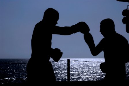 US Navy 091014-N-8960W-025 Operations Specialist 2nd Class Henry Mejia spars with Operations Specialist 3rd Class Danny Aldana in the hangar bay of the aircraft carrier USS Nimitz (CVN 68) photo