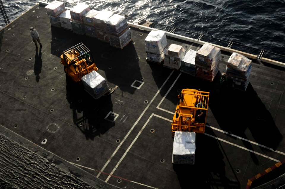 US Navy 091015-N-3038W-277 Sailors assigned to the supply department of the aircraft carrier USS Nimitz (CVN 68) move supplies during a replenishment at sea with the Military Sealift Command fast combat support ship USNS Bridge