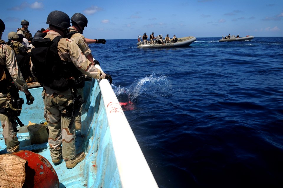 US Navy 091015-N-4154B-351 Members of a visit, board, search and seizure team from the guided-missile cruiser USS Anzio (CG 68) and U.S. Coast Guard Maritime Safety and Security Team 91104 dispose of bags of illegal narcotics.