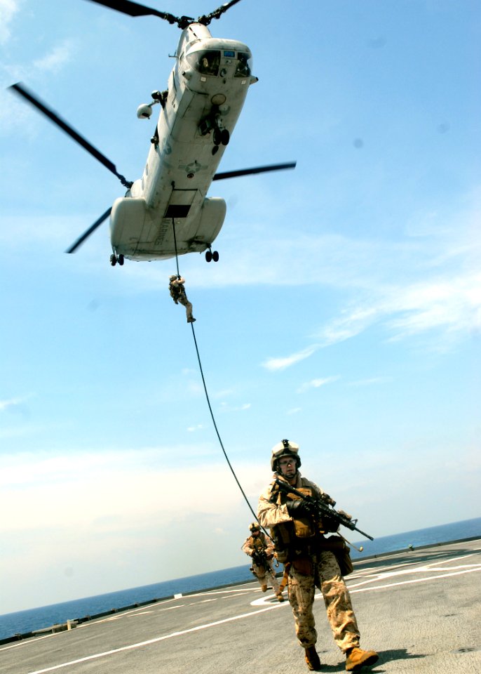 US Navy 091014-N-5148B-148 Marines assigned to the 11th Marine Expeditionary Unit (11th MEU) embarked aboard the dock landing ship USS Rushmore (LSD 47) fast rope out of a CH-46E Sea Knight helicopter onto the flight deck