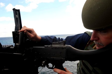US Navy 091017-N-2147L-003 Chief Gunner's Mate Richard Daue checks the barrel of an M-240 machine gun after a live-fire exercise aboard the amphibious transport dock ship Pre-Commissioning Unit (PCU) New York (LPD 21 photo