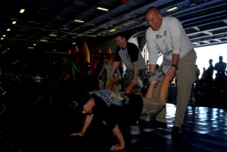 US Navy 091016-N-5586R-177 Sailors and Tiger Cruise participants compete in a wheelbarrow race aboard the aircraft carrier USS Ronald Reagan (CVN 76)