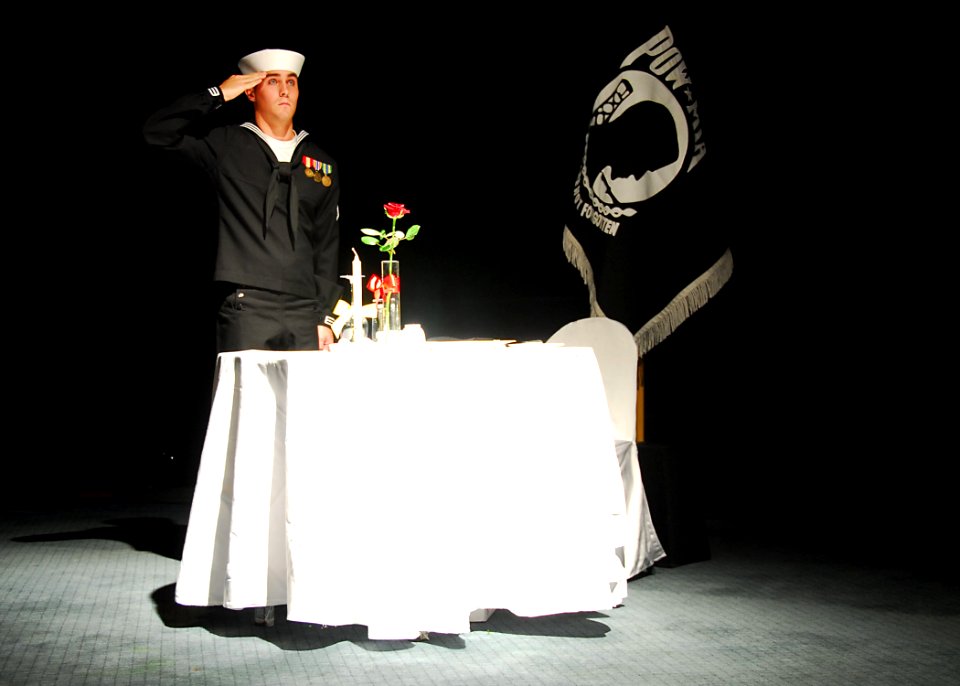 US Navy 091017-N-9573A-031 Information Systems Technician Sean Jonathan Timm, assigned to Commander, U.S. Naval Forces Korea, renders honors to the Prisoner of War-Missing in Action table during the 234th Navy Birthday Ball in