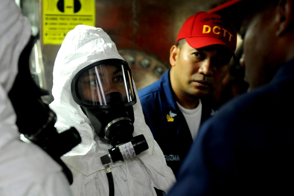 US Navy 091017-N-7280V-181 Damage control training team members train Information Systems Technician 3rd Class Jonetta McCoy, a flying squad team member, during a toxic gas drill aboard the amphibious command ship USS Blue Ridg