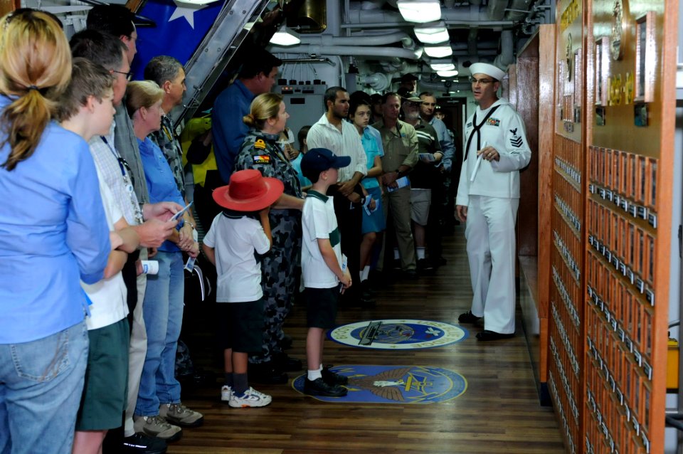 US Navy 091015-N-7478G-003 Mass Communication Specialist 1st Class Todd MacDonald gives a tour of the amphibious command ship USS Blue Ridge (LCC 19) for Cairns residents