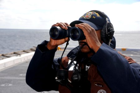 US Navy 091017-N-2147L-001 Boatswain's Mate Seaman Darius Magee stands watch on the flight deck of the amphibious transport dock ship Pre-Commissioning Unit (PCU) New York (LPD 21) photo