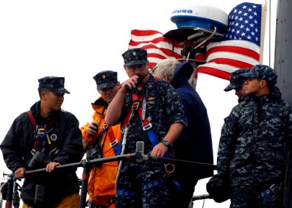 US Navy 091015-N-7705S-056 Cmdr. David Alldridge assigned to the Los Angeles-class attack submarine USS Newport News (SSN 750) communicates with the pier photo