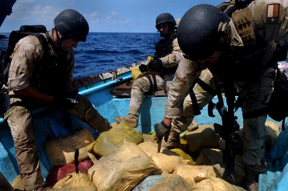 US Navy 091015-N-4154B-303 Members of a visit, board, search and seizure team from the guided-missile cruiser USS Anzio (CG 68) and U.S. Coast Guard Maritime Safety and Security Team 91104 dispose of bags of illegal narcotics