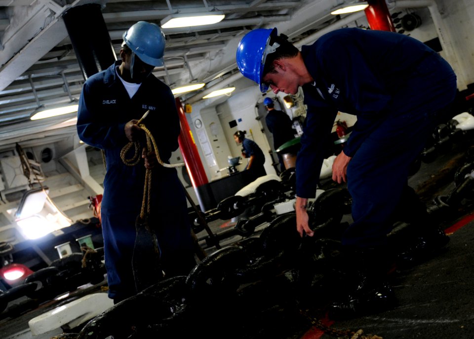 US Navy 091016-N-3830J-150 eaman Robert Chittenden and Seaman Raymond Lovelace lock the anchor chain