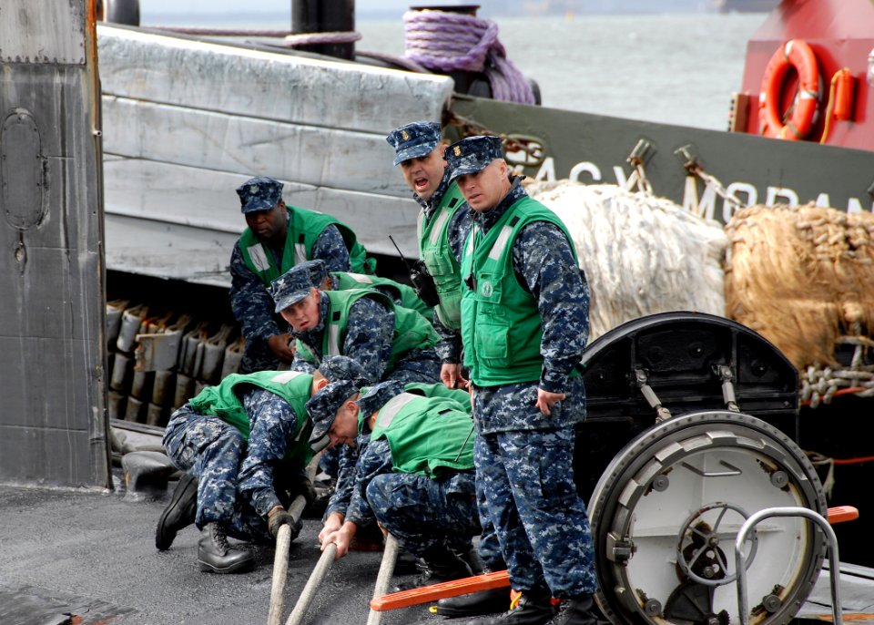 US Navy 091015-N-7705S-063 Sailors aboard the Los Angeles-class attack submarine USS Newport News (SSN 750) tend to the mooring lines