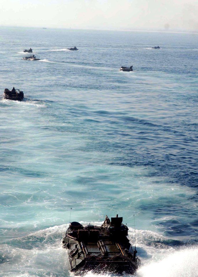 US Navy 091017-N-5148B-035 Amphibious assault vehicles assigned to the 11th Marine Expeditionary Unit (11th MEU) debark the well deck of the dock landing ship USS Rushmore (LSD 47) and head for the Indonesian shore to support