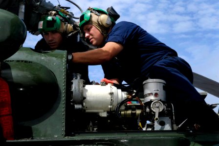 US Navy 091017-N-7478G-269 Aviation Structural Mechanic 1st Class Lawrence Smathers, right, instructs Aviation Structural Mechanic 3rd Class Adam Lawrence while performing maintenance on an SH-60F Sea Hawk helicopter aboard the