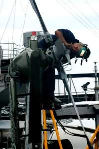 US Navy 091019-N-7478G-139 Aviation Electrician's Mate 3rd Class Shaun Williams, assigned to Light Helicopter Antisubmarine Squadron (HSL) 51, performs preventive maintenance on the tail of an SH-60F Sea Hawk helicopter