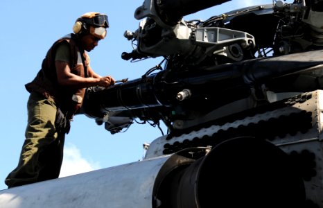 US Navy 091016-N-0890S-050 Lance Cpl. Leon Meeks, assigned to the Iron Horses of Marine Helicopter Squadron (HMH) 461 (Heavy), performs corrosion prevention on a CH-53E Super Stallion helicopter photo