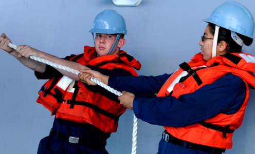 US Navy 091016-N-7478G-234 Seaman Joshua Kuschel and Seaman Elsa Orsonio handle lines aboard