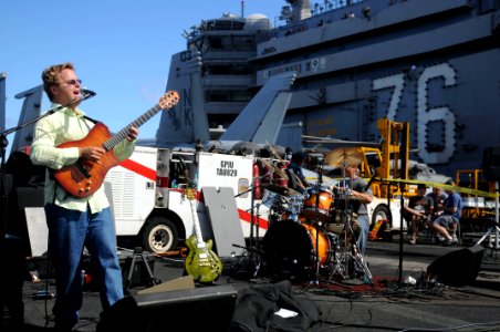 US Navy 091016-N-9132C-416 Sailors and Tiger Cruise participants listen to a jazz concert with Steve Oliver on the flight deck aboard the aircraft carrier USS Ronald Reagan (CVN 76)