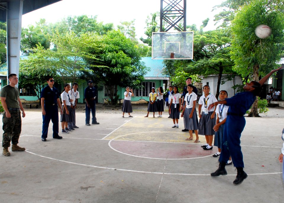 US Navy 091015-N-6692A-101 Sailors and Marines assigned to the amphibious dock landing ship USS Tortuga (LSD 46) play volleyball with students from Sangley Point National High School during a lunch break at a community service