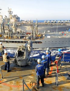 US Navy 091016-N-1831S-259 Sailors aboard the amphibious dock landing ship USS Fort McHenry (LSD 43) watch as the Military Sealift Command fleet replenishment oiler USNS Kanawha (T-AO 196) conducts an underway replenishment