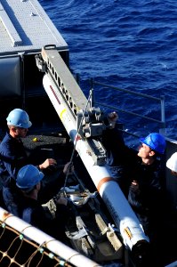 US Navy 091017-N-0890S-010 Sailors load a RIM-7M Sea Sparrow surface-to-air missile into a launcher aboard the multi-purpose amphibious assault ship USS Wasp (LHD 1)