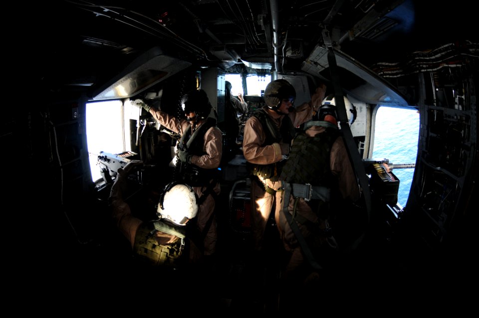 US Navy 091020-N-0890S-093 Marines assigned to the Iron Horses of Marine Heavy Helicopter Squadron (HMH) 461, fire .50-caliber machine guns in a CH-53E Super Stallion helicopter
