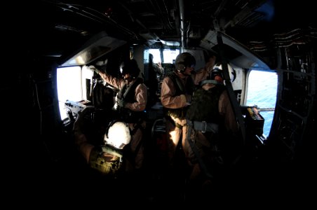US Navy 091020-N-0890S-093 Marines assigned to the Iron Horses of Marine Heavy Helicopter Squadron (HMH) 461, fire .50-caliber machine guns in a CH-53E Super Stallion helicopter