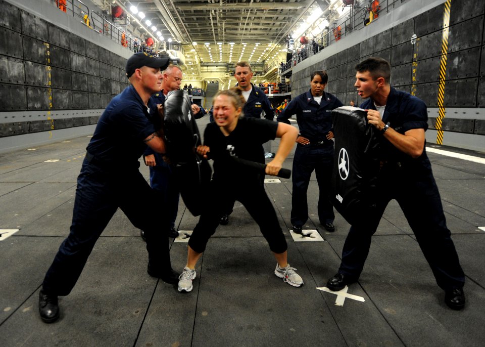 US Navy 091017-N-2147L-002 Fire Controlman 3rd class Mary Spell fights through an obstacle in the oleo resin capsicum (OC) qualification course in the well deck of the amphibious transport dock ship Pre-Commissioning Unit (PCU