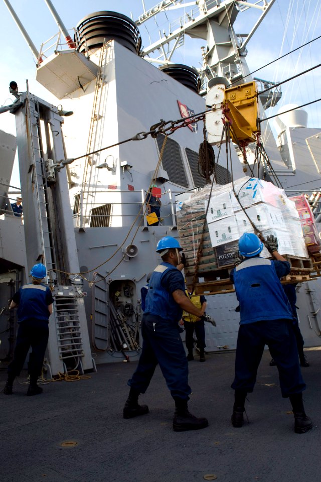 US Navy 091017-N-9123L-053 Sailors aboard the guided-missile destroyer USS McCampbell (DDG 85) guide stores from the Military Sealift Command fleet replenishment oiler USNS Pecos (T-AO-197) to the deck during an underway replen