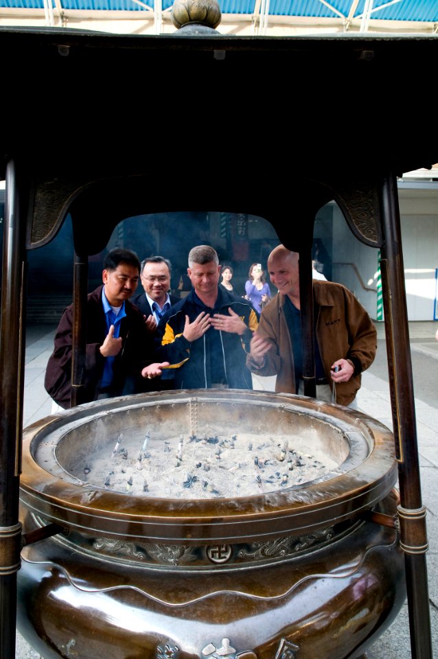 US Navy 091020-N-1251W-042 Master Chief Petty Officer of the Navy (MCPON) Rick West, center, observes an incense urn at the entrance of Sensoji Temple along with U.S. 7th Fleet Command Master Chief Marcos Sibal