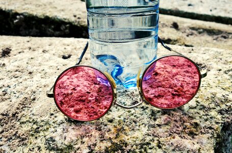 Pink glasses water bottle still photo