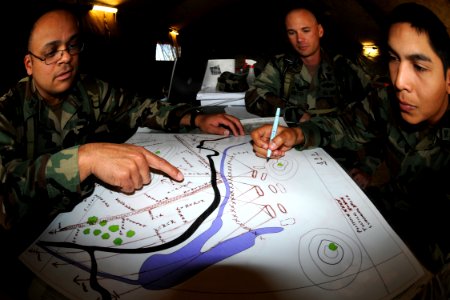 US Navy 091021-N-1424C-783 Sailors assigned to Amphibious Construction Battalion (ACB) 1 practice drawing and evaluating a fire plan which is part of the Seabee Combat Warfare qualification