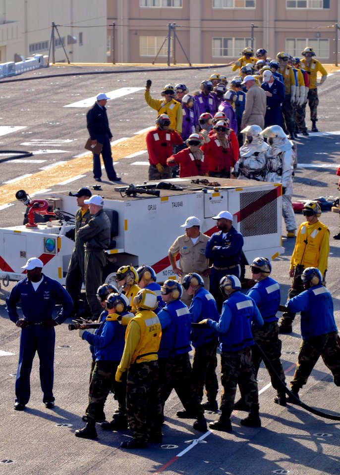 US Navy 091021-N-9950J-039 Sailors assigned to the air department of the forward-deployed amphibious assault ship USS Essex (LHD 2) participate in a fire drill for their annual Aviation Certification