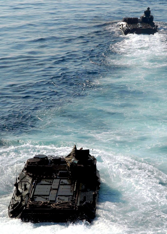 US Navy 091017-N-5148B-006 Two amphibious assault vehicles assigned to the 11th Marine Expeditionary Unit (11th MEU) debark the well deck of the dock landing ship USS Rushmore (LSD 47) and head for the Indonesian shore to suppo
