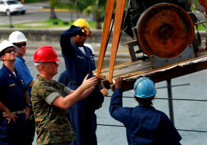 US Navy 091021-N-0807W-236 Sailors and Marines load equipment aboard the amphibious dock landing ship USS Harpers Ferry (LSD 49)