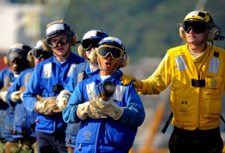 US Navy 091021-N-9950J-241 Sailors assigned to the air department of the forward-deployed amphibious assault ship USS Essex (LHD 2) participate in a fire drill for their annual Aviation Certification. Essex is in a ship's restr
