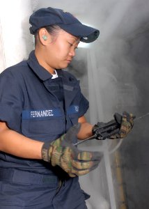 US Navy 091021-N-5215E-007 Machinist's Mate Fireman Jessica Hernandez prepares a wire for tying a flange shield
