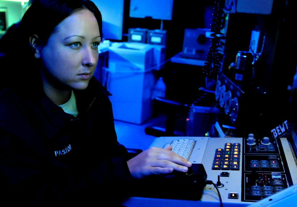 US Navy 091019-N-7478G-090 Cryptologic Technician (Technical) Seaman Jennifer Pastor stands watch at the Surface Electronics Emission Console (SLQ-32) in the combat information center aboard the amphibious command ship USS Blue