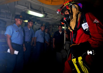 US Navy 091019-N-0807W-152 Philippine sailors observe the damage control team assigned to the amphibious dock landing ship USS Harpers Ferry (LSD 49) demonstrate the proper procedure for combating a fire photo