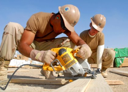 US Navy 091017-N-9564W-095 Construction Electrician 2nd Class Daniel Arteche, left, from Santa Rosa, Calif., and Construction Electrician 2nd Class Alyssa Copp, from Somerset, Mass