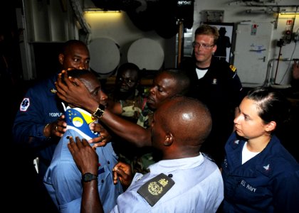 US Navy 091020-N-1429M-022 Sierra Leone navy Chief Petty Officer Abdul Karim Konteh, bottom, and Leading Seaman Samuel Kerifa Mansaray, center, prepare a standing spine board for a Ghana navy petty officer photo