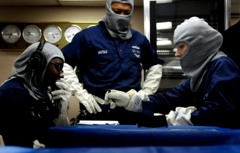 US Navy 091021-N-7280V-362 Seaman Lashaunda Foster, left, and Seaman Jennifer Gee review status reports in Damage Control Central while Culinary Specialist 1st