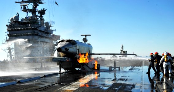 US Navy 091020-N-6003P-006 A fire team hoses down the Mobile Aircraft Firefighting Training Device (MAFTD) aboard the aircraft carrier USS Harry S. Truman